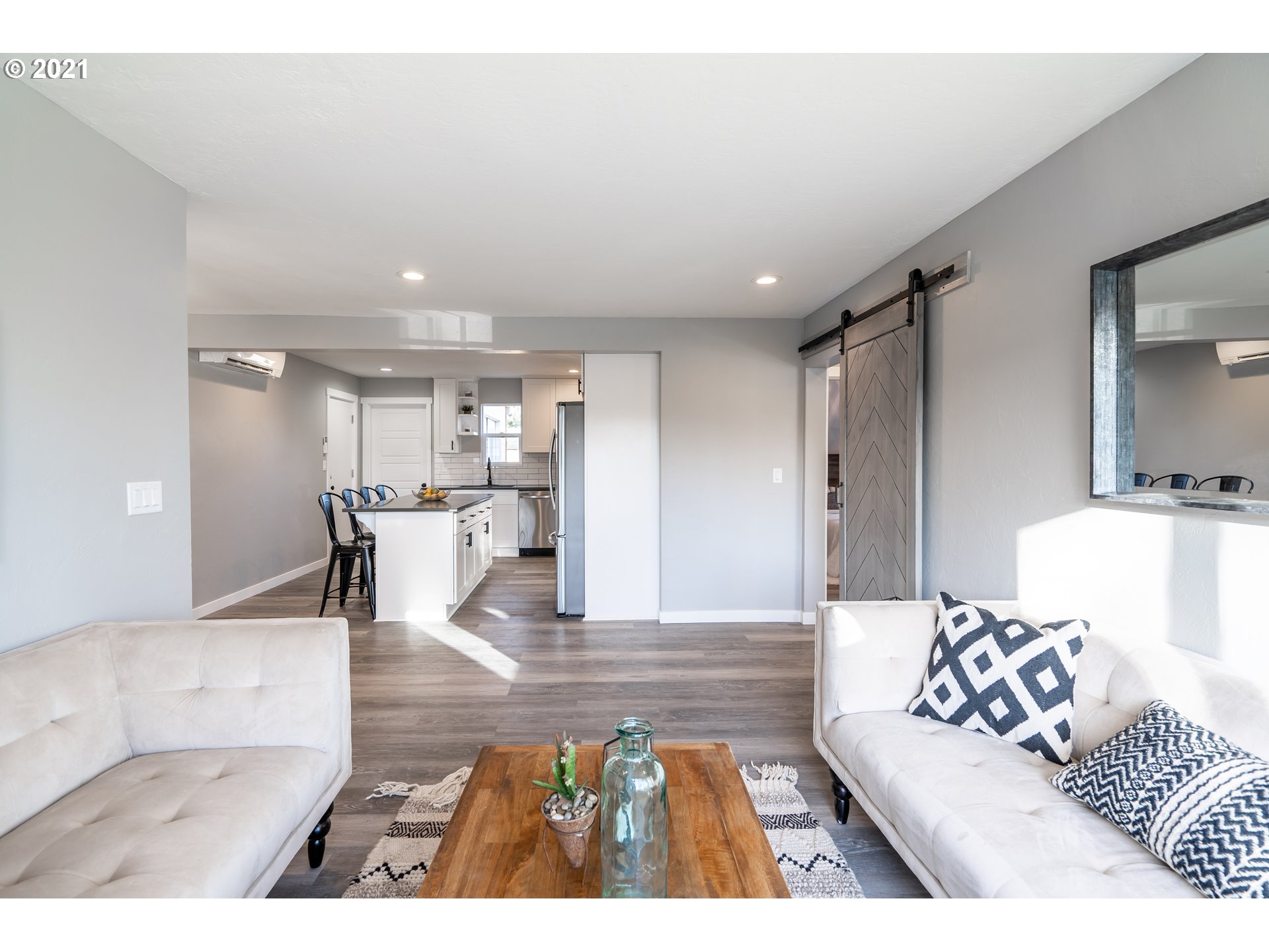 1214 L Street Springfield, OR 97477 - Photo 12 of 24 a living room with furniture and a dining table with kitchen view