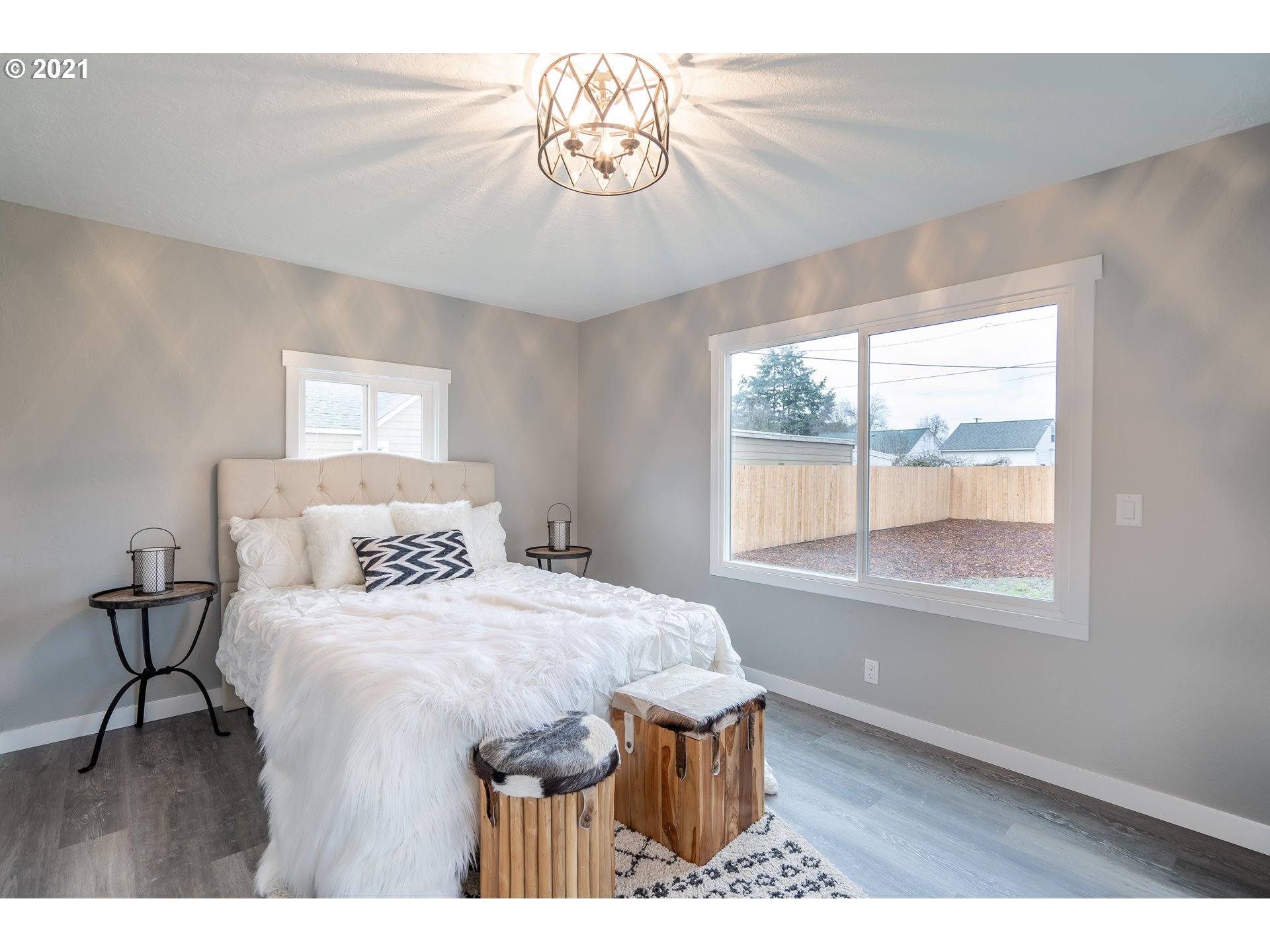 1214 L Street Springfield, OR 97477 - Photo 14 of 24 a bedroom with a bed and a table with lamp