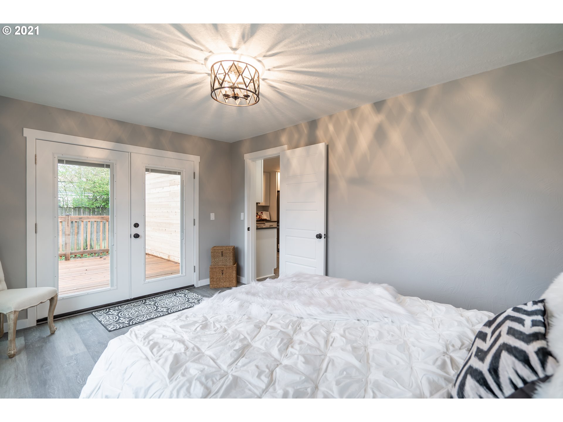 1214 L Street Springfield, OR 97477 - Photo 15 of 24 a bedroom with a large bed and a chandelier