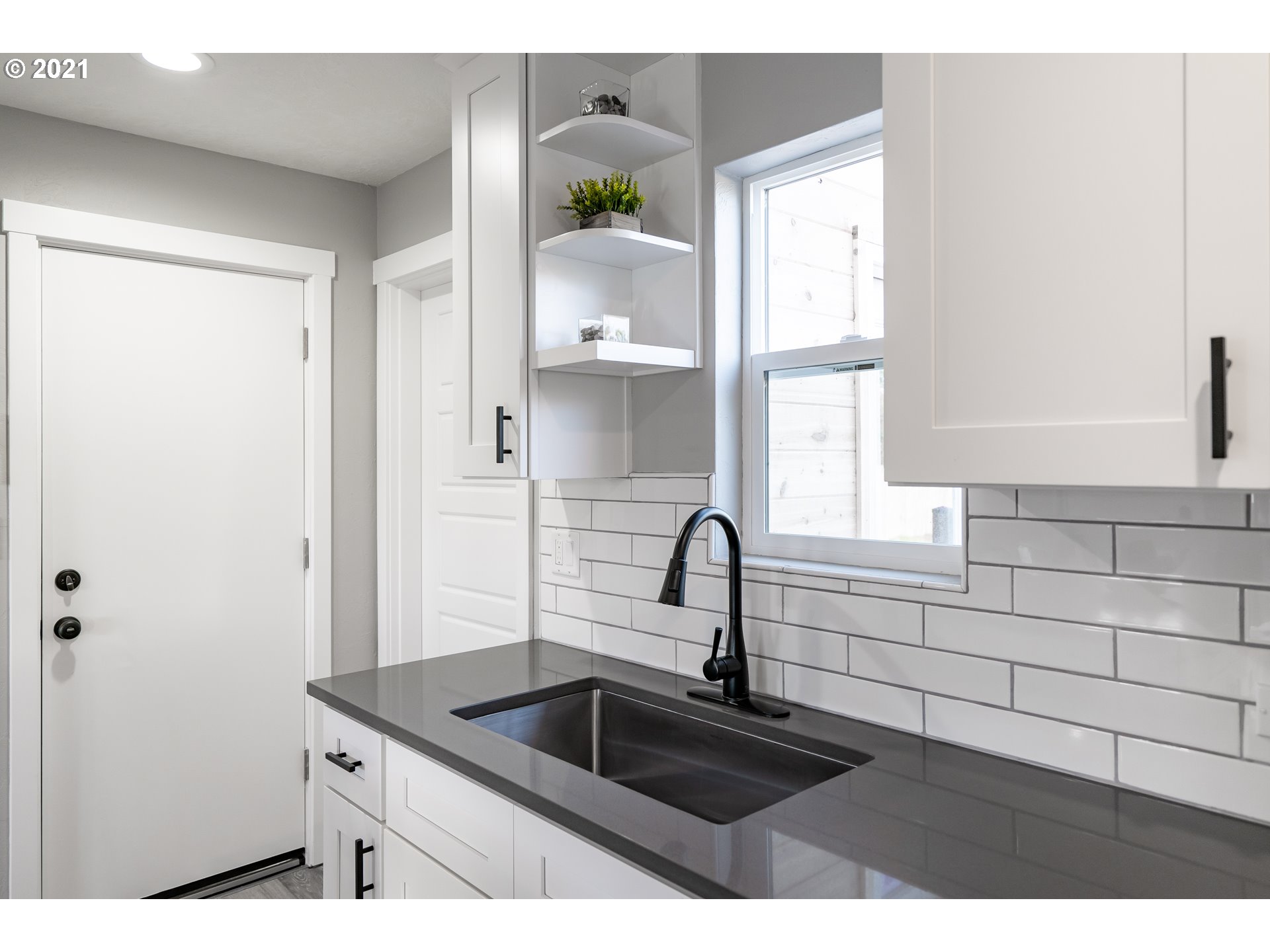 1214 L Street Springfield, OR 97477 - Photo 7 of 24 a kitchen with a sink and a window