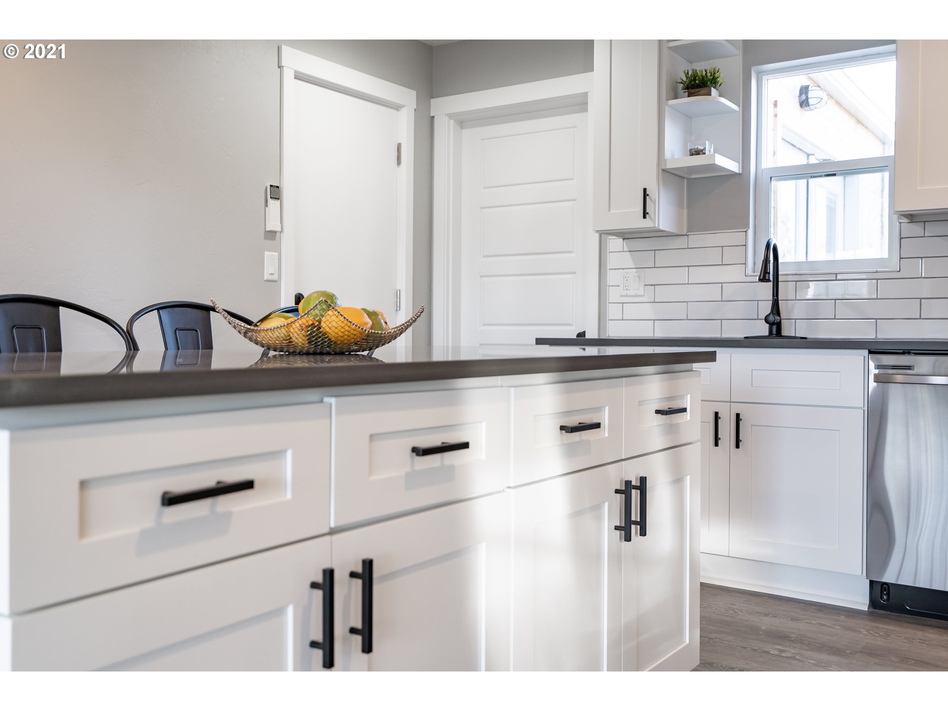 1214 L Street Springfield, OR 97477 - Photo 10 of 24 a kitchen with granite countertop white cabinets and white appliances