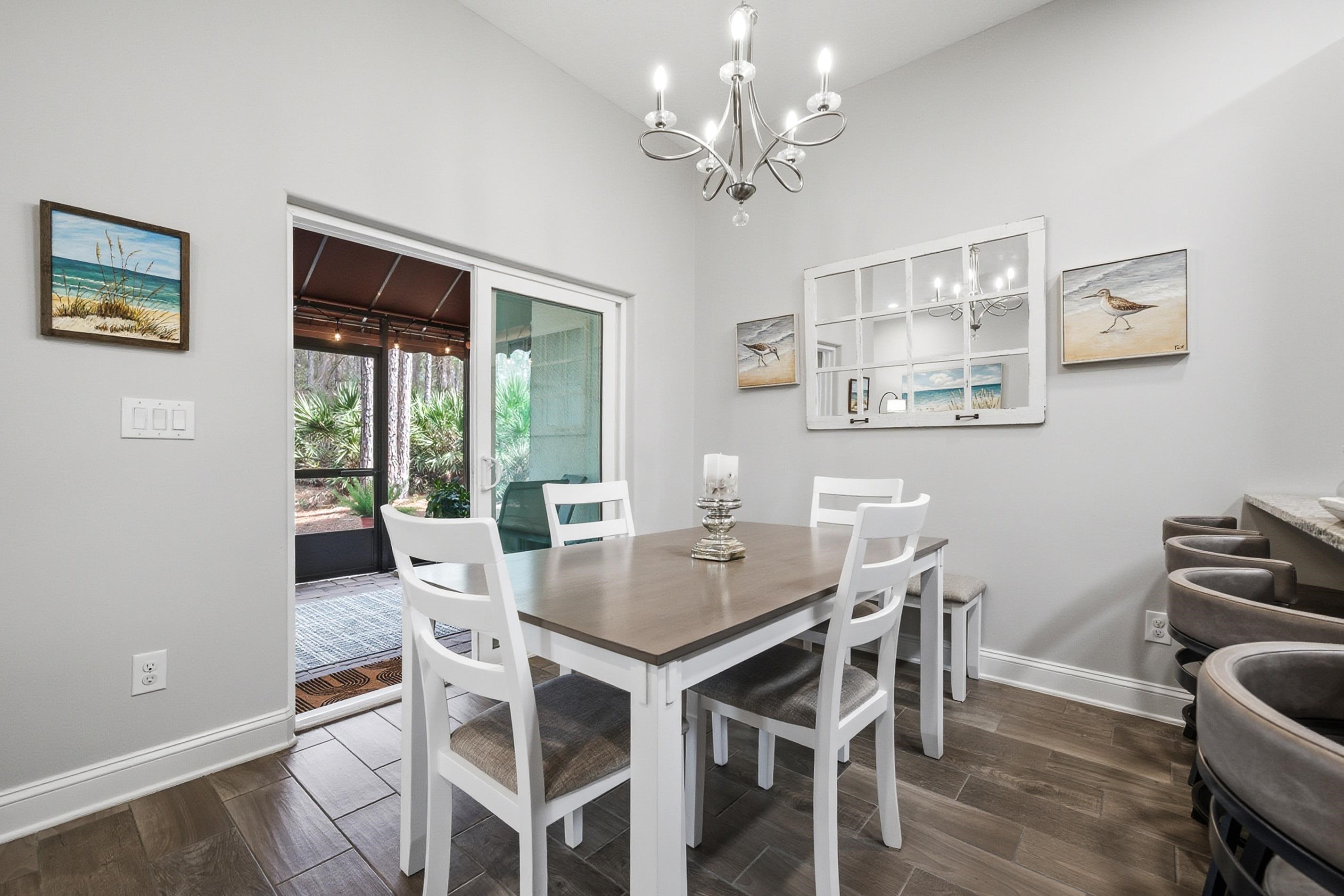 200 Grand Ravine Drive St. Augustine, FL 32086 - Photo 11 of 34 Dining space featuring wood tiled floors and a chandelier