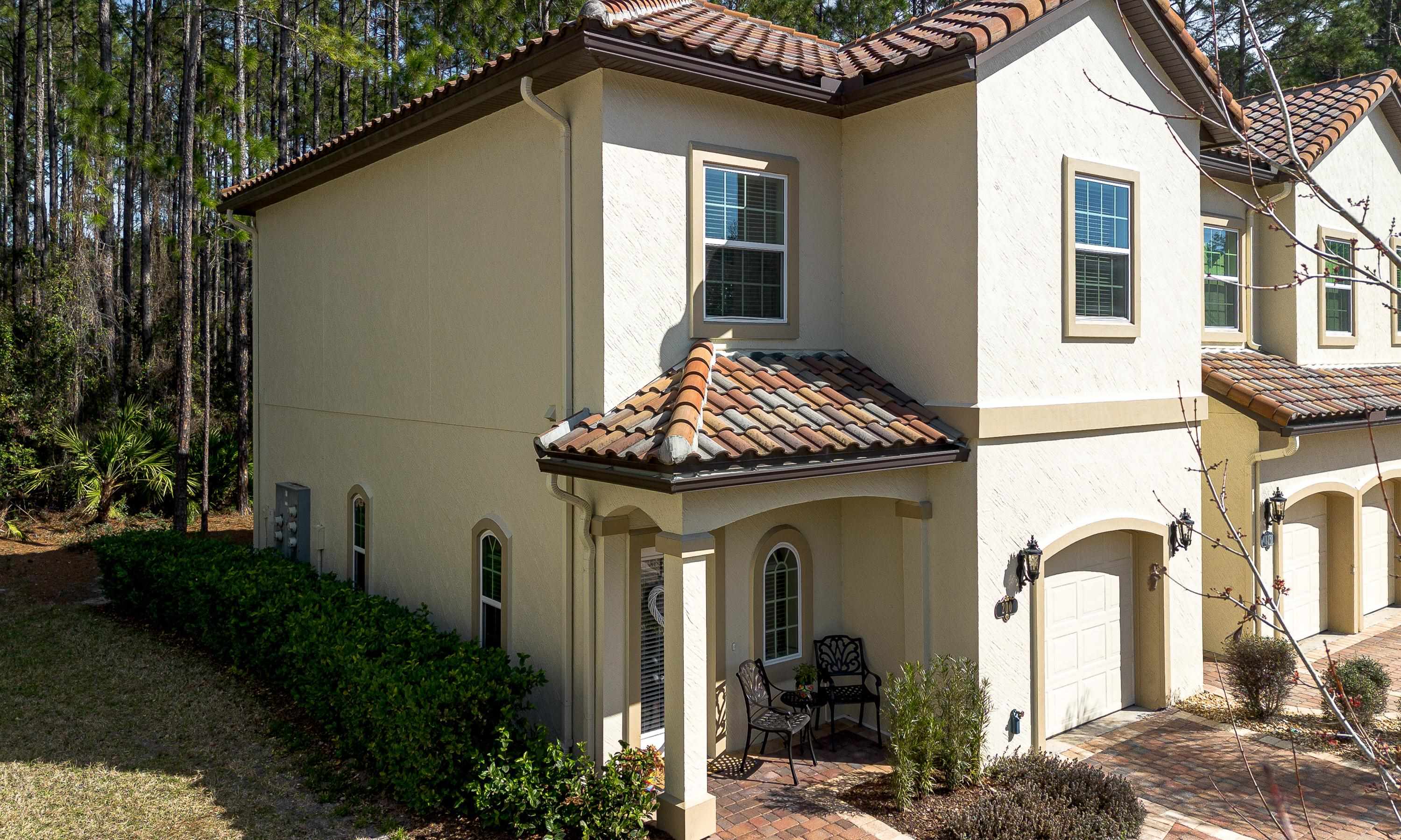 200 Grand Ravine Drive St. Augustine, FL 32086 - Photo 2 of 34 View of front of house featuring a garage, stucco siding, a tile roof, and decorative driveway