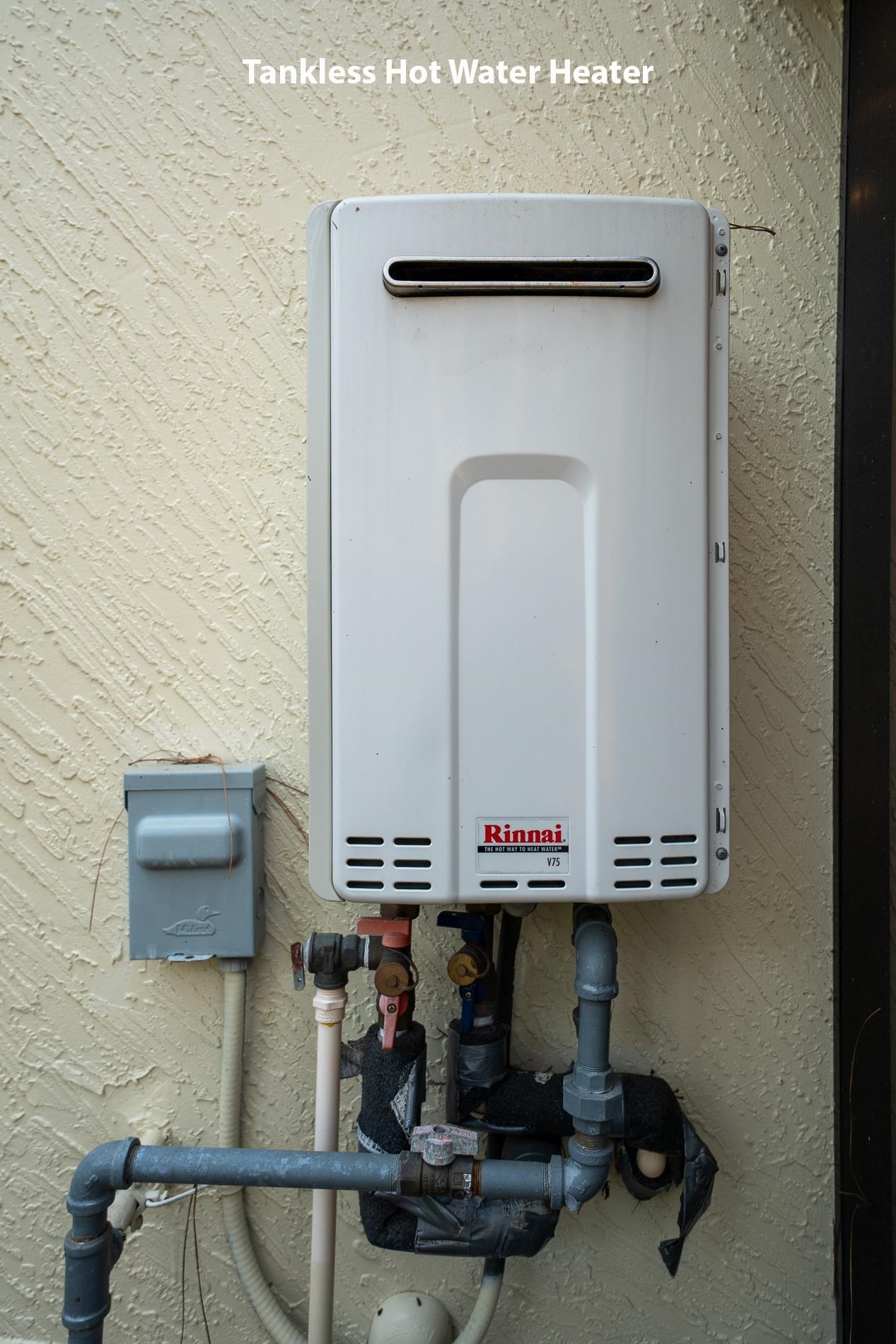 200 Grand Ravine Drive St. Augustine, FL 32086 - Photo 27 of 34 Exterior view of water heater and stucco siding