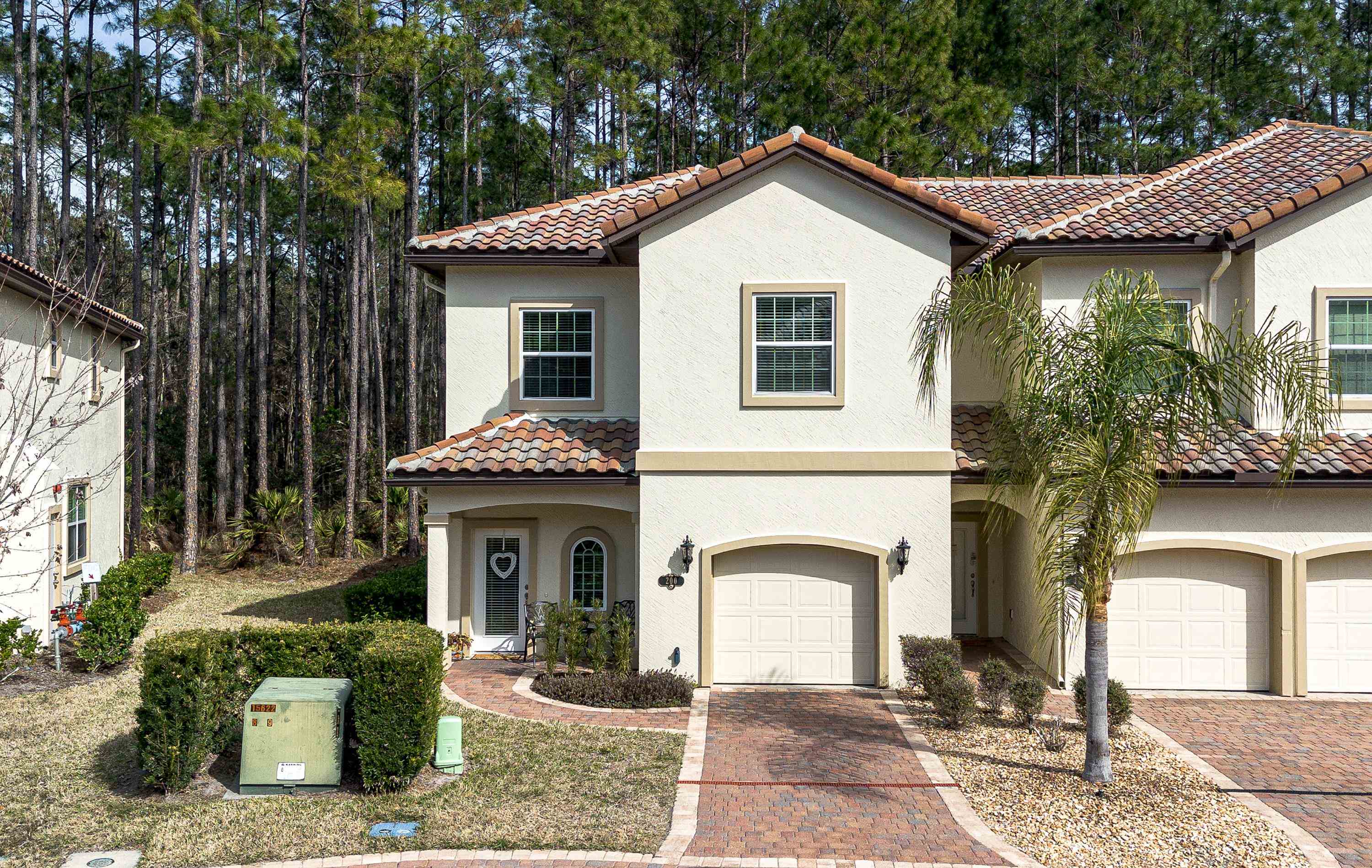 200 Grand Ravine Drive St. Augustine, FL 32086 - Photo 30 of 34 Mediterranean / spanish house featuring stucco siding, an attached garage, decorative driveway, and a tile roof
