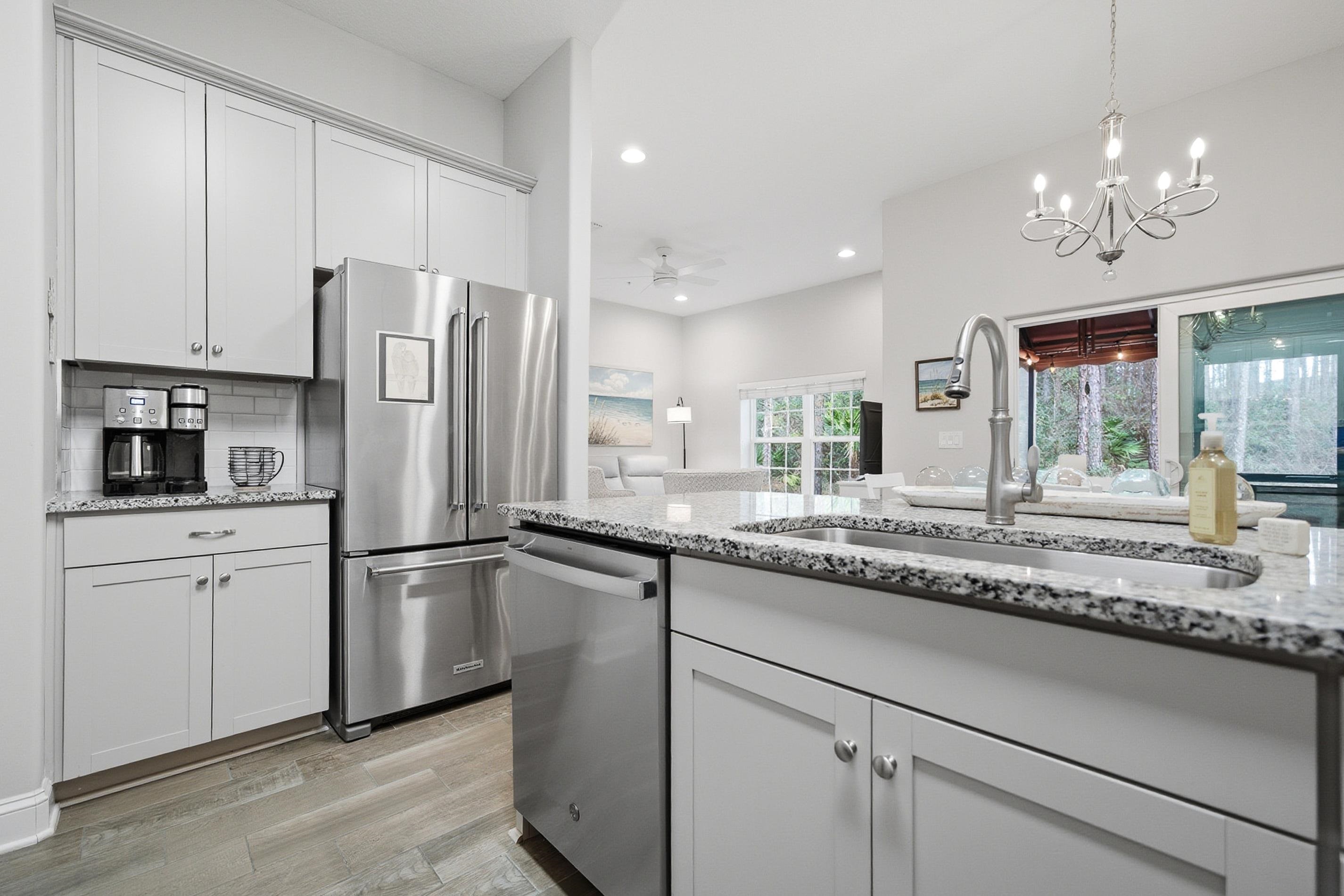 200 Grand Ravine Drive St. Augustine, FL 32086 - Photo 9 of 34 Kitchen with light stone counters, stainless steel appliances, a ceiling fan, light wood-style floors, and white cabinets