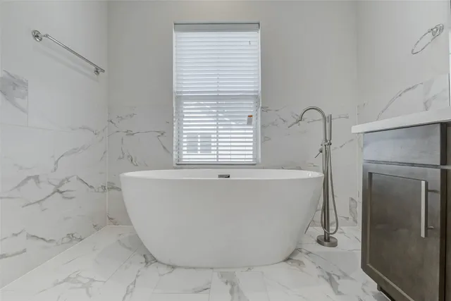 a white bath tub sitting in a bathroom