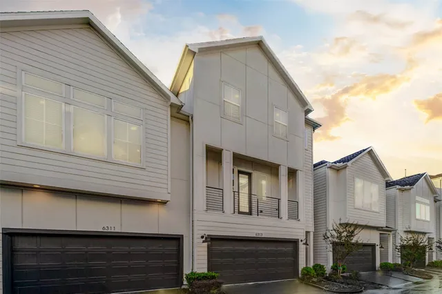 a view of a white house with many windows