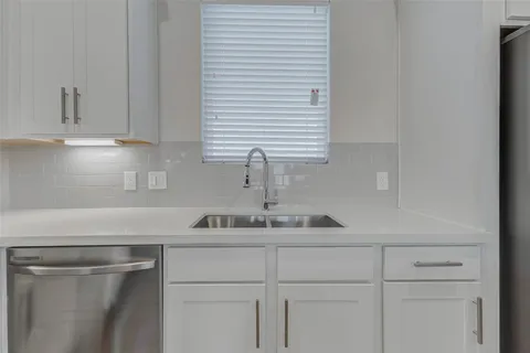a kitchen with a sink and cabinets