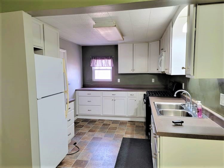 1784 Mound Hill Road Dixon, IL 61021 - Photo 8 of 17 a kitchen with a refrigerator sink and cabinets