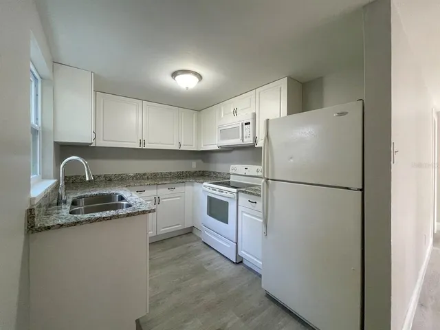 a white refrigerator freezer sitting in a kitchen