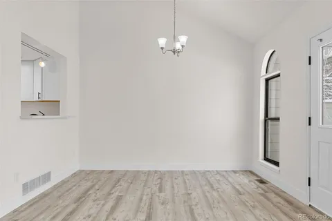 a view of a room with wooden floor and white walls
