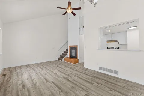 a view of empty room with wooden floor