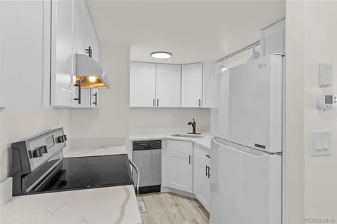 a kitchen that has a sink and a stove in it