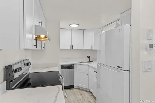 a kitchen that has a sink and a stove in it