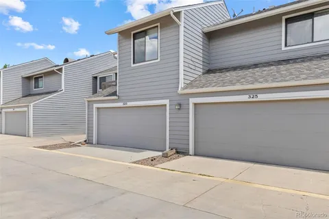 a view of a yard with yellow lighting