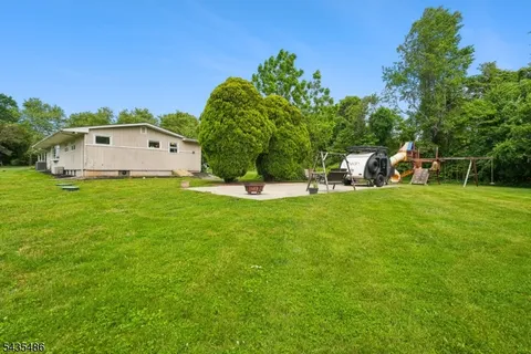 a backyard of a house with table and chairs