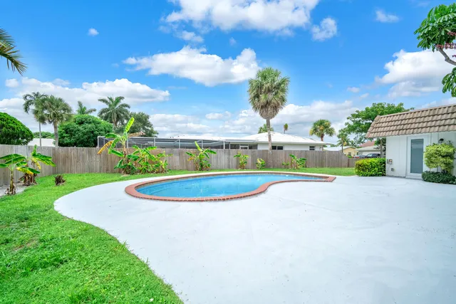 a view of a swimming pool with a yard