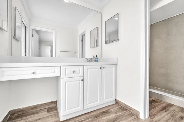 a bathroom with a sink a mirror and a vanity