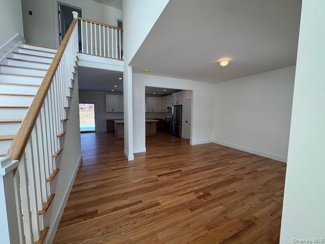 Lot #9 Colonels Path Manorville, NY 11949 - Photo 3 of 26 a view of a hallway with wooden floor and staircase