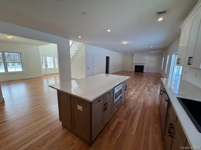 Lot #9 Colonels Path Manorville, NY 11949 - Photo 26 of 26 a kitchen with kitchen island wooden floors and center island