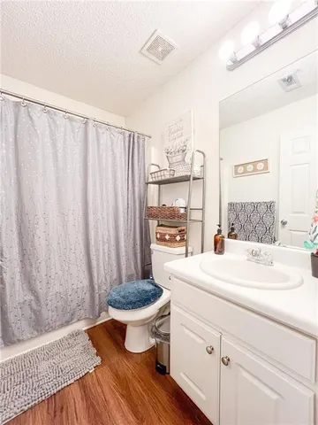 a living room with a sink and a table with wooden floor