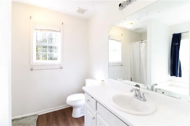a bathroom with a toilet sink and mirror