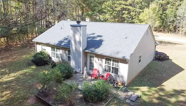 a view of a house with yard and potted plants