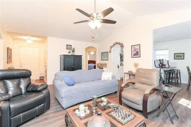 a living room with furniture and a chandelier