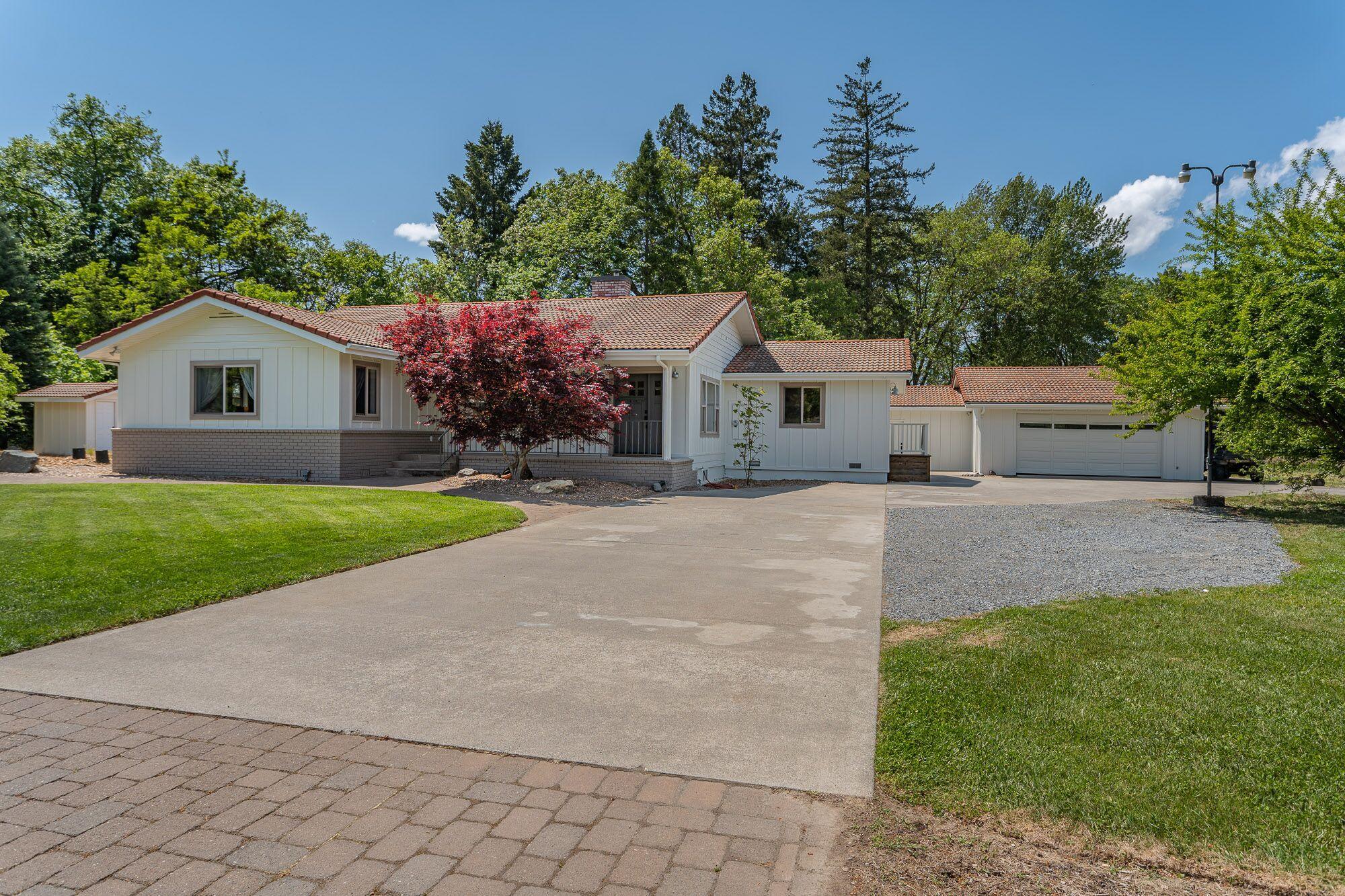 3134 South River Road Grants Pass, OR 97527 - Photo 3 of 38 a front view of a house with a yard and garage