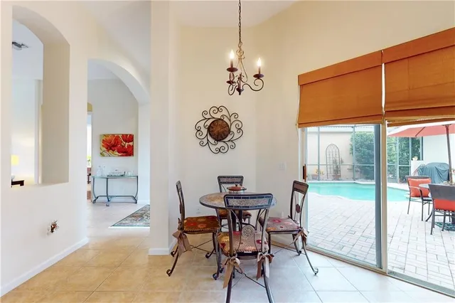 a view of a dining room with furniture wooden floor and a chandelier