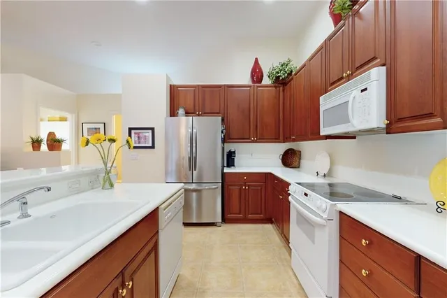 a kitchen with a sink a refrigerator and a stove