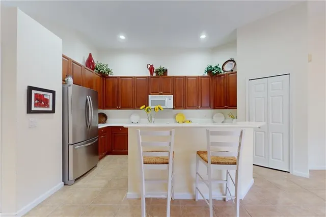 a kitchen with stainless steel appliances a refrigerator and a stove top oven
