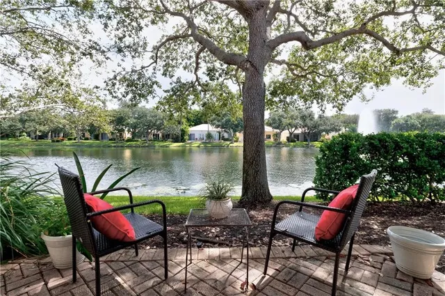 a view of a lake with outdoor seating space