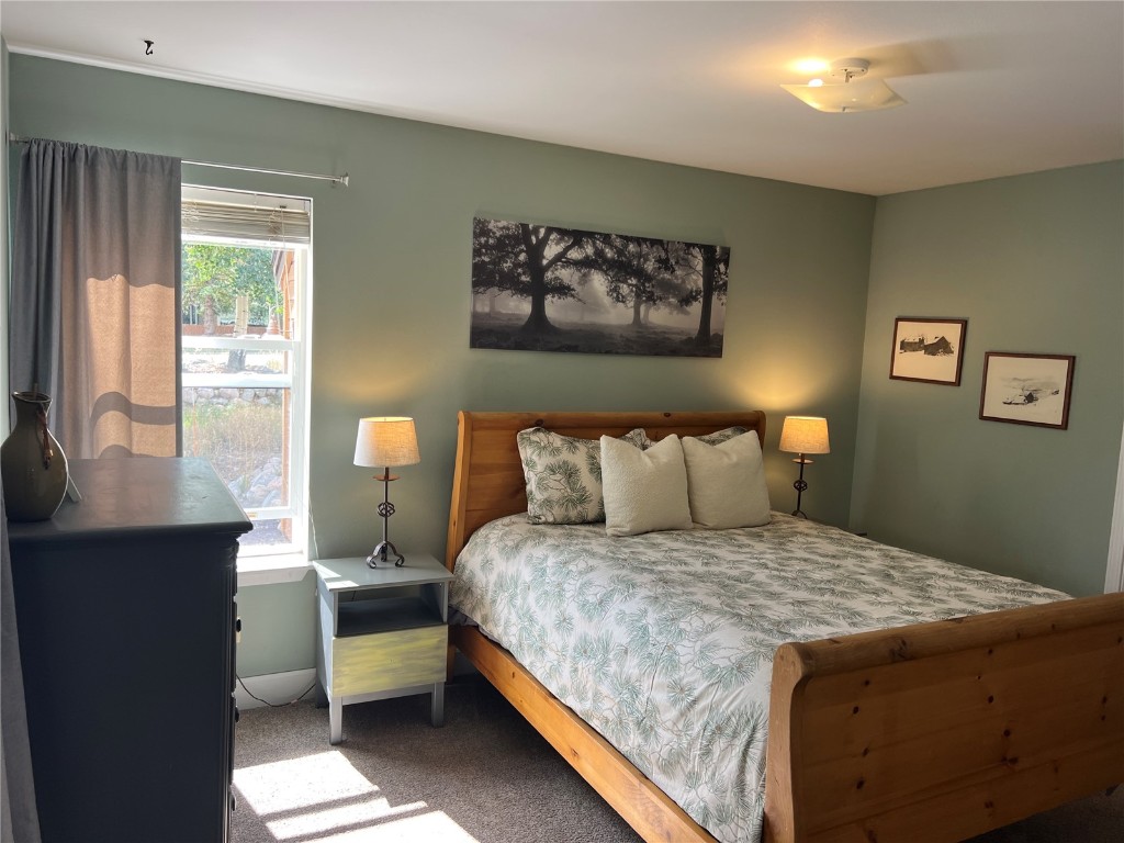 147 Blue Grouse Lane Silverthorne, CO 80498 - Photo 14 of 50 a bedroom with a large bed and a desk