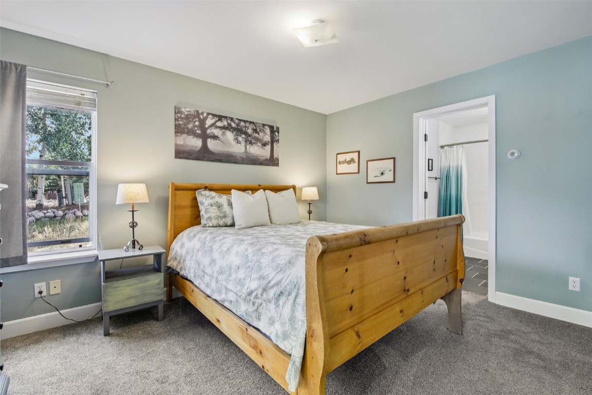 147 Blue Grouse Lane Silverthorne, CO 80498 - Photo 26 of 50 a bedroom with a bed and window