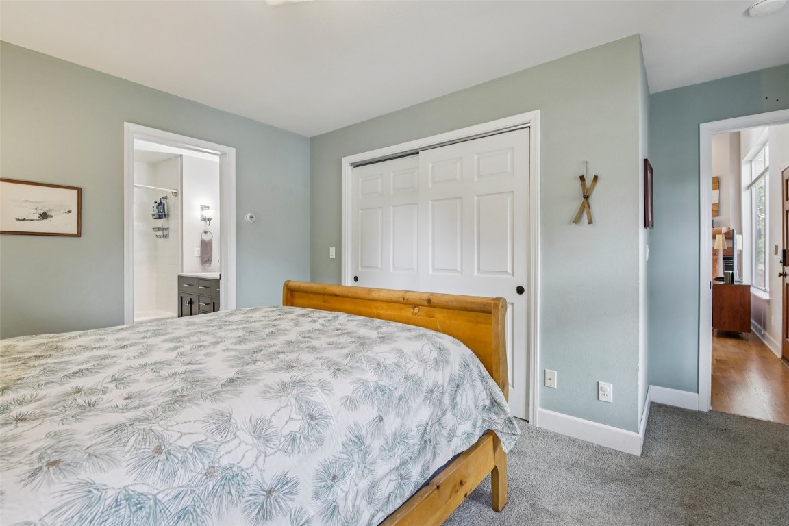 147 Blue Grouse Lane Silverthorne, CO 80498 - Photo 27 of 50 a bedroom with a bed and a mirror
