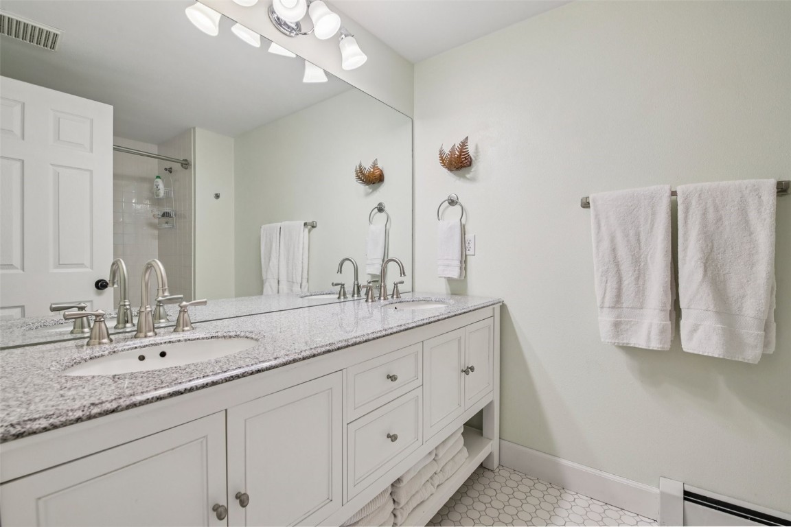 147 Blue Grouse Lane Silverthorne, CO 80498 - Photo 31 of 50 a bathroom with a double vanity sink and a mirror