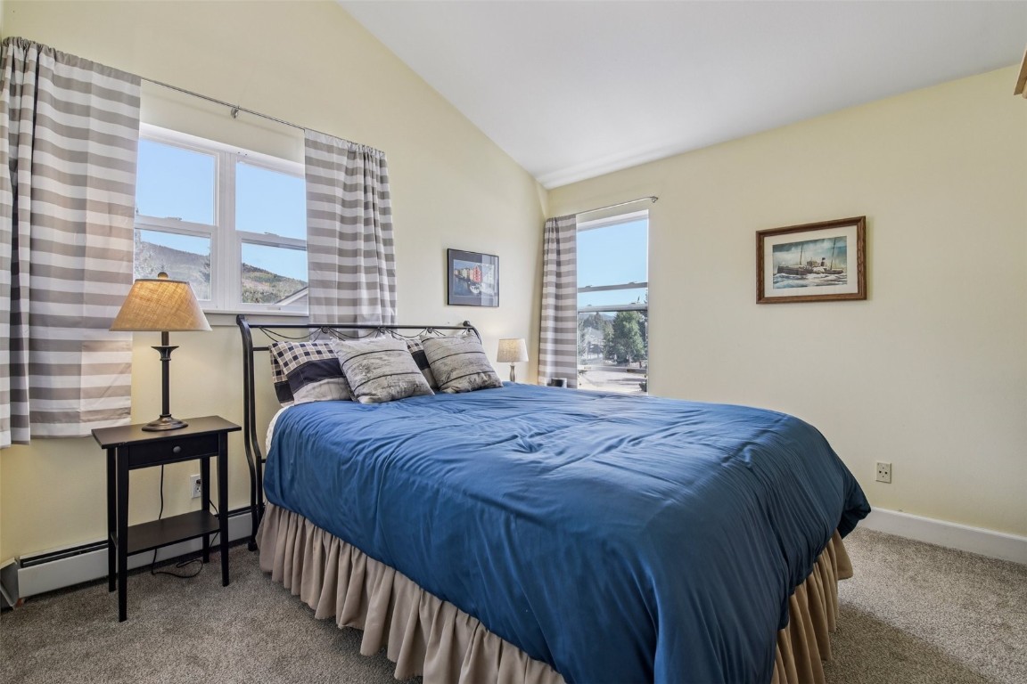 147 Blue Grouse Lane Silverthorne, CO 80498 - Photo 33 of 50 a bed sitting in a bedroom next to a window