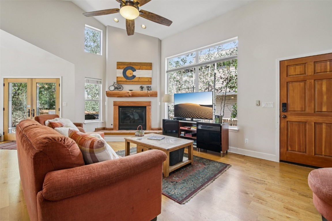 147 Blue Grouse Lane Silverthorne, CO 80498 - Photo 4 of 50 a living room with furniture a fireplace and a flat screen tv