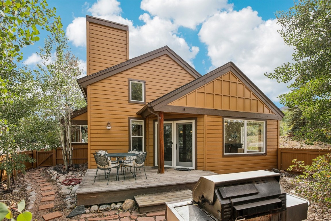 147 Blue Grouse Lane Silverthorne, CO 80498 - Photo 41 of 50 a view of a house with a chairs and table in a patio