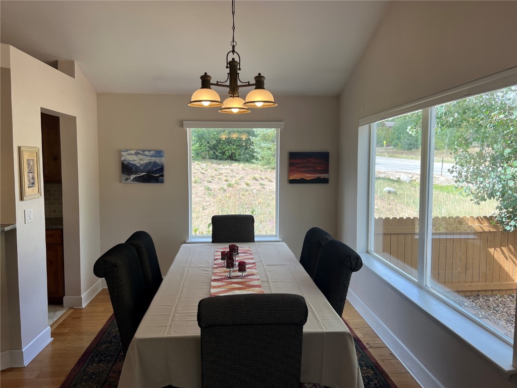 147 Blue Grouse Lane Silverthorne, CO 80498 - Photo 47 of 50 a dining room with furniture a chandelier and wooden floor