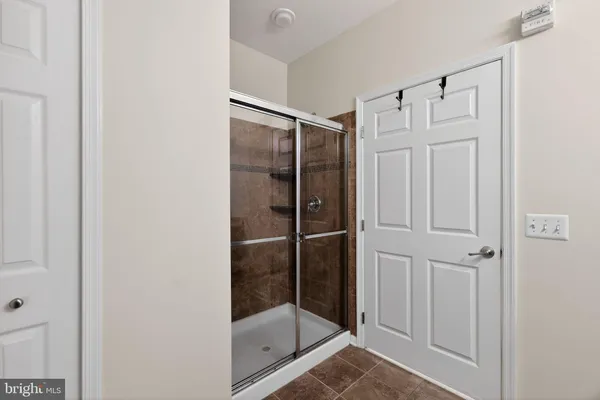 a bathroom with a glass shower door