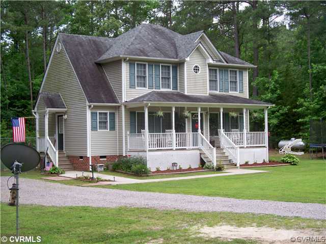 8001 Holdsworth Road Disputanta, VA 23842 - Photo 1 of 6 a front view of a house with a yard table and chairs
