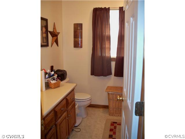 8001 Holdsworth Road Disputanta, VA 23842 - Photo 6 of 6 a bathroom with a toilet sink and mirror