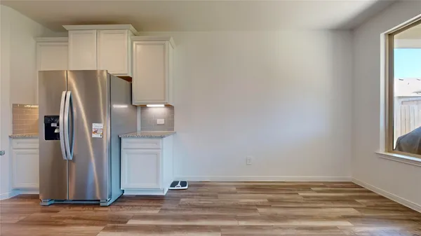 a kitchen with stainless steel appliances granite countertop a refrigerator and a stove top oven