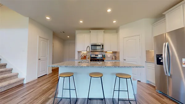 a kitchen with stainless steel appliances granite countertop a stove and a sink