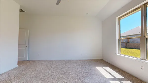 a bedroom with a flat screen tv and a bed