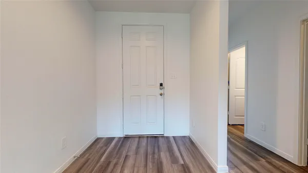 a view of a hallway with wooden floor