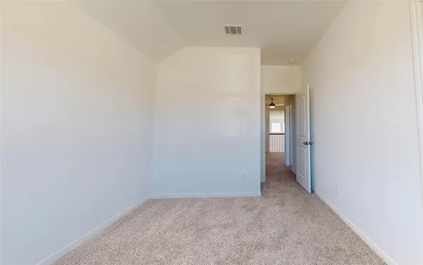 a bedroom with a bed and a table in it next to a window